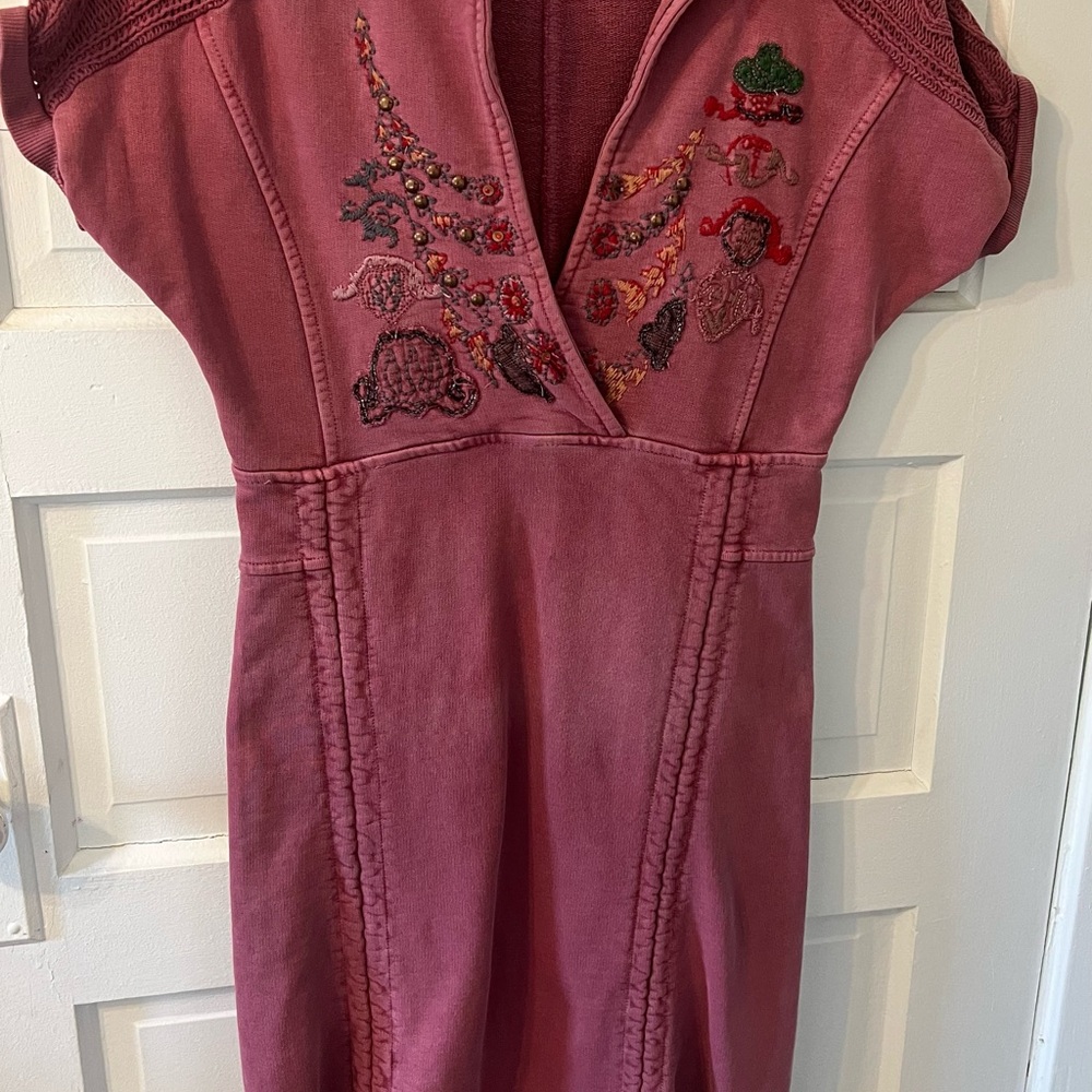 This is a unique women’s dress. It has a very intricate design on it.